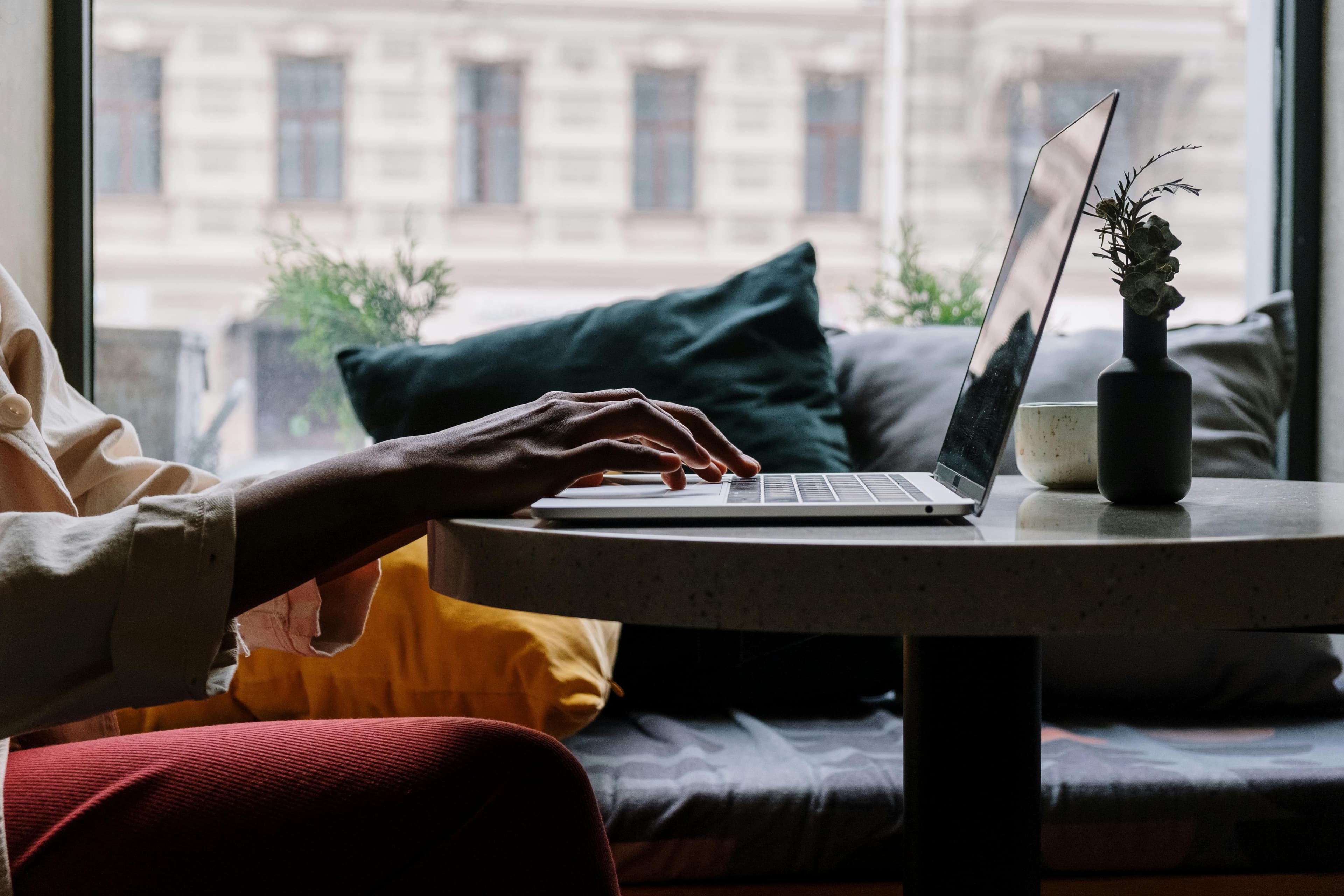 Person working on laptop in a cozy environment