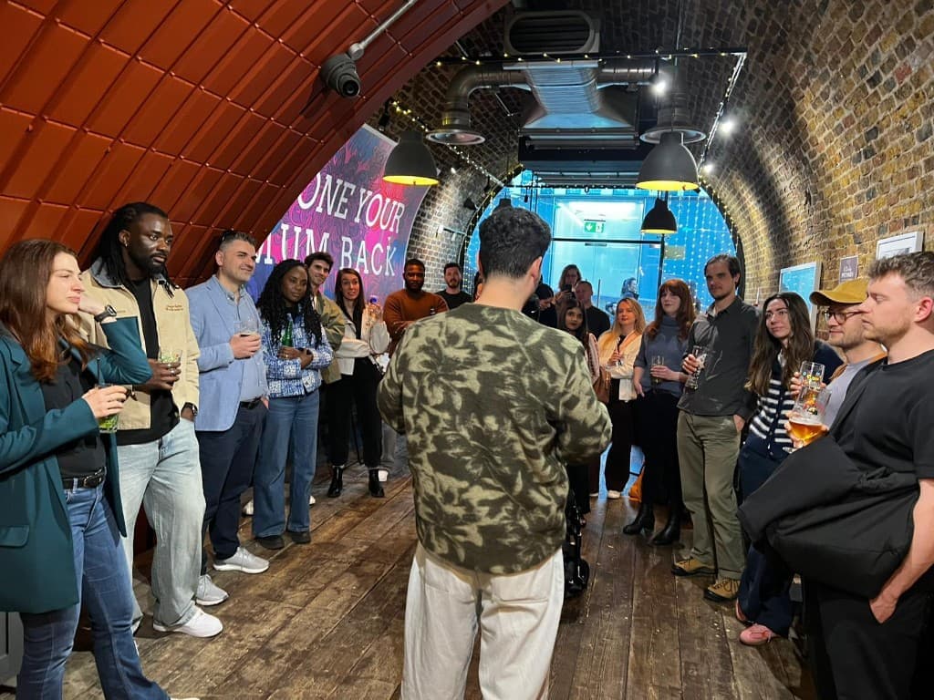 Attendees gathered in a warm brick venue for a networking event