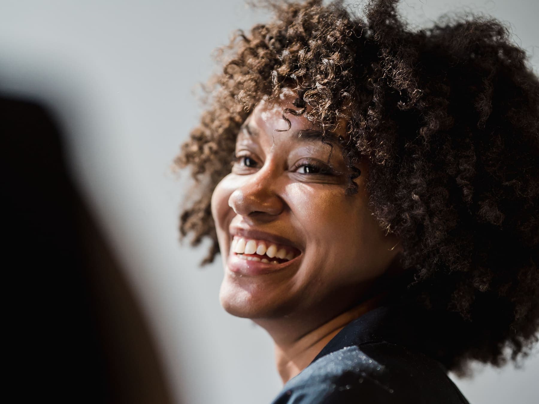 A woman laughing during a conversation