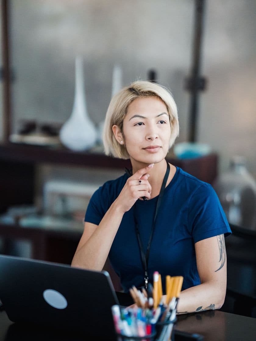A team member thinking through a problem at her desk